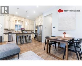 A kitchen with a table and chairs in the middle of the room.