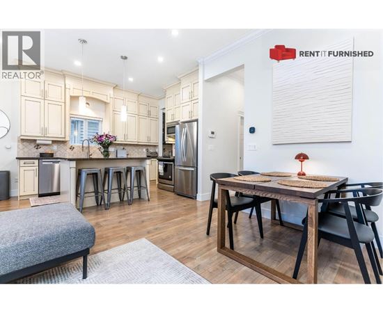 A kitchen with a table and chairs in the middle of the room.