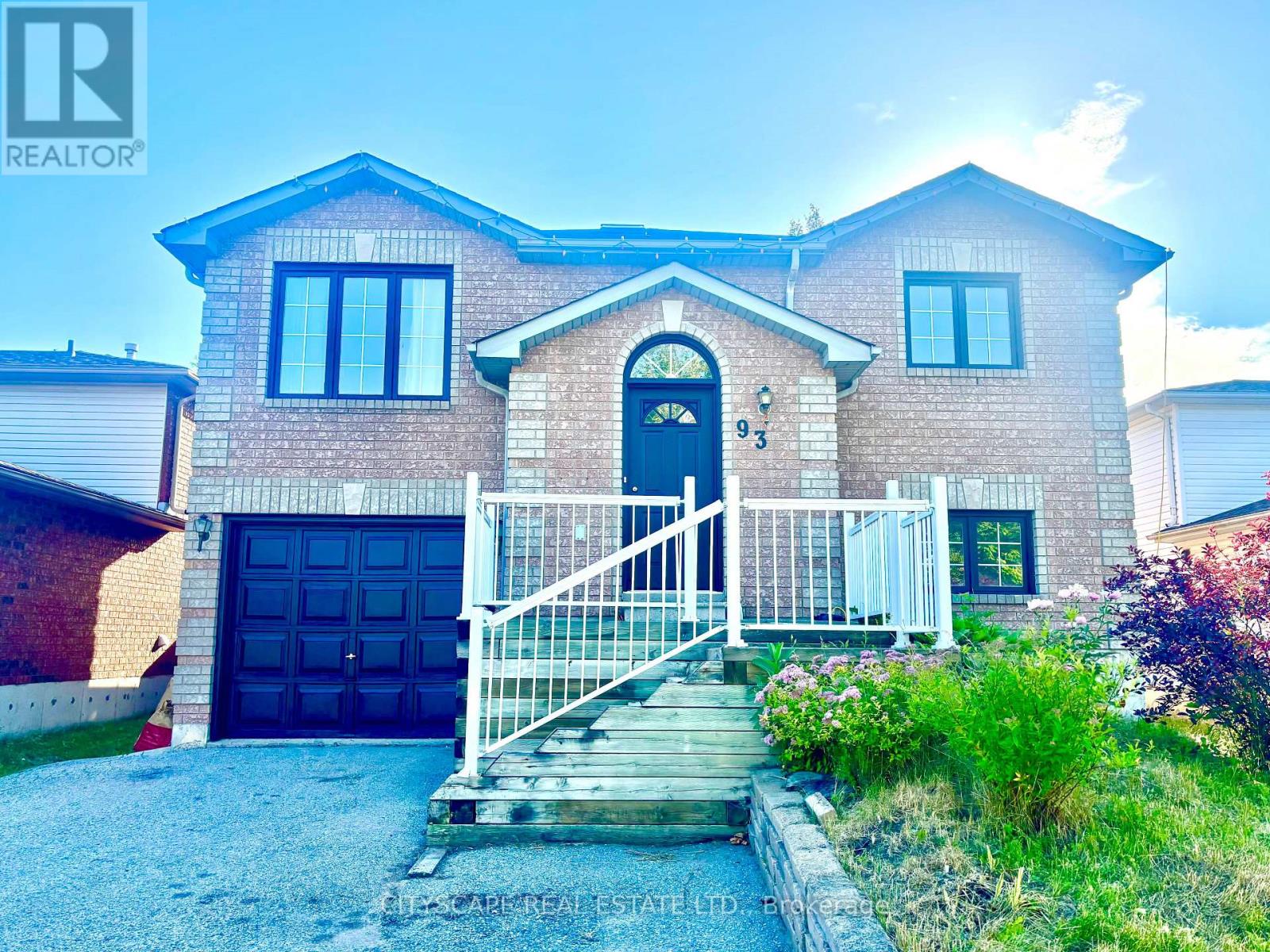 A house with a blue door and a white fence in front.