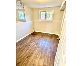 A room with wooden flooring and a window.