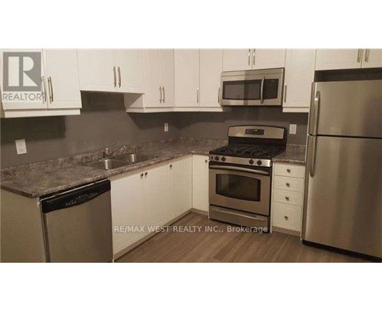 A kitchen with white cabinets and stainless steel appliances.