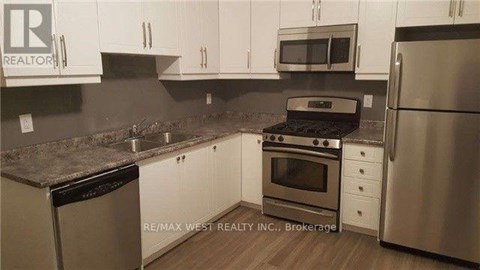 A kitchen with white cabinets and stainless steel appliances.