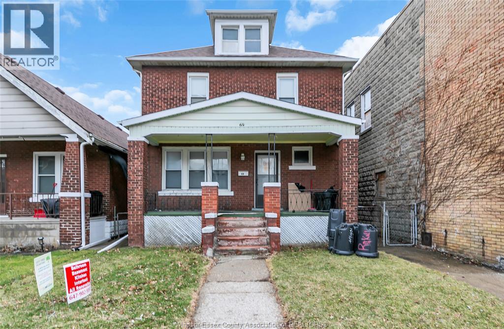 A house with a sign in front of it that says for sale.