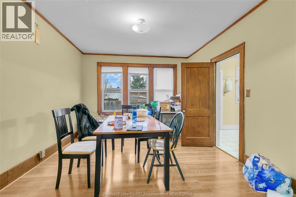 A dining room with a table set for four.