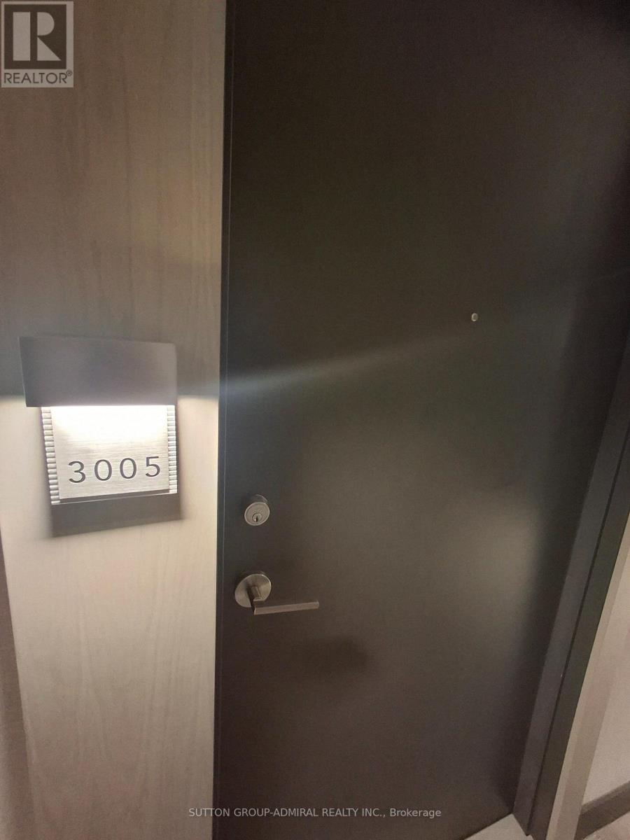 A door with a number plate on it and a sign above it.