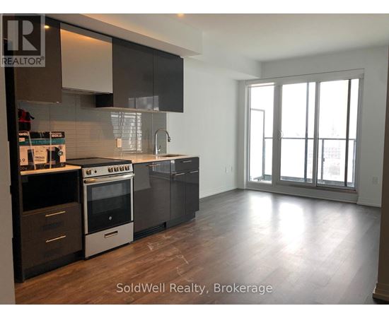 A kitchen with a stove top oven and a refrigerator.