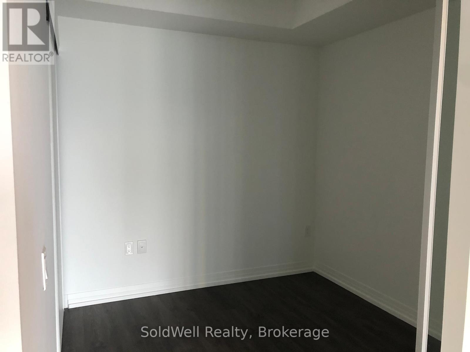 A room with white walls and a black floor.