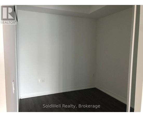 A room with white walls and a black floor.
