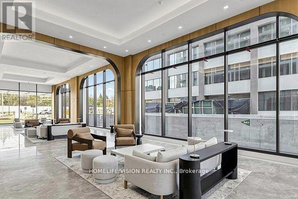 A spacious lobby with a reception desk and seating area.