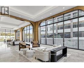 A spacious lobby with a reception desk and seating area.