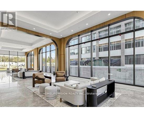 A spacious lobby with a reception desk and seating area.