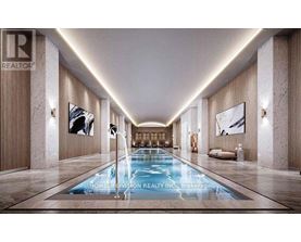 A long, narrow indoor swimming pool with a lighted floor.