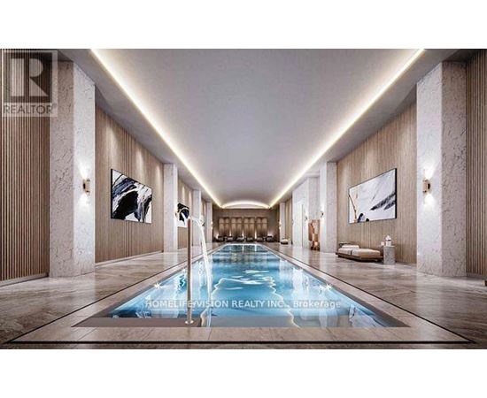 A long, narrow indoor swimming pool with a lighted floor.