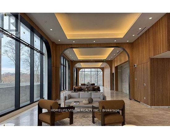 A modern living room with a long wooden table and chairs.