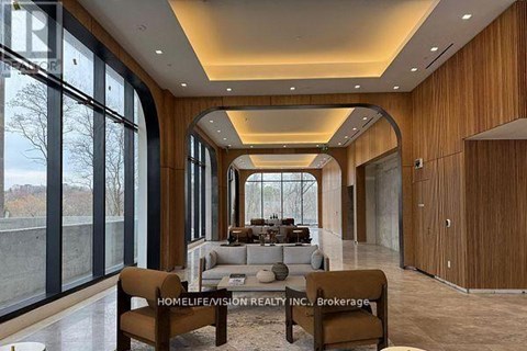 A modern living room with a long wooden table and chairs.