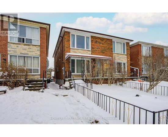 A snow-covered ground with a building in the background.
