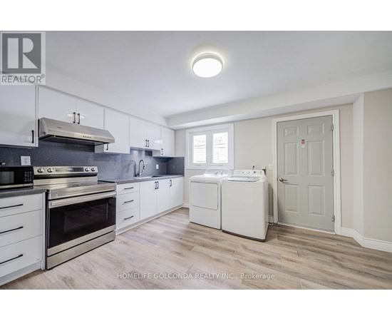 A kitchen with white cabinets and appliances.