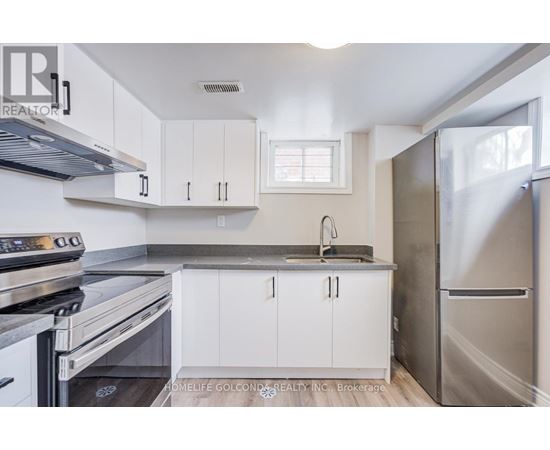 A kitchen with white cabinets and stainless steel appliances.