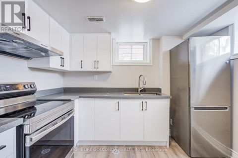 A kitchen with white cabinets and stainless steel appliances.