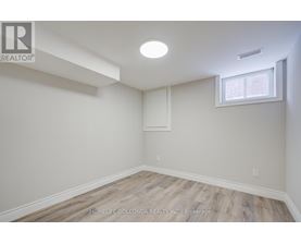 A room with a window and a light on the ceiling.