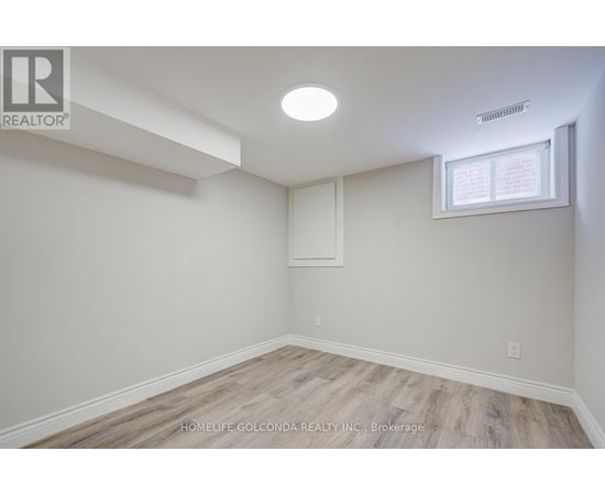 A room with a window and a light on the ceiling.