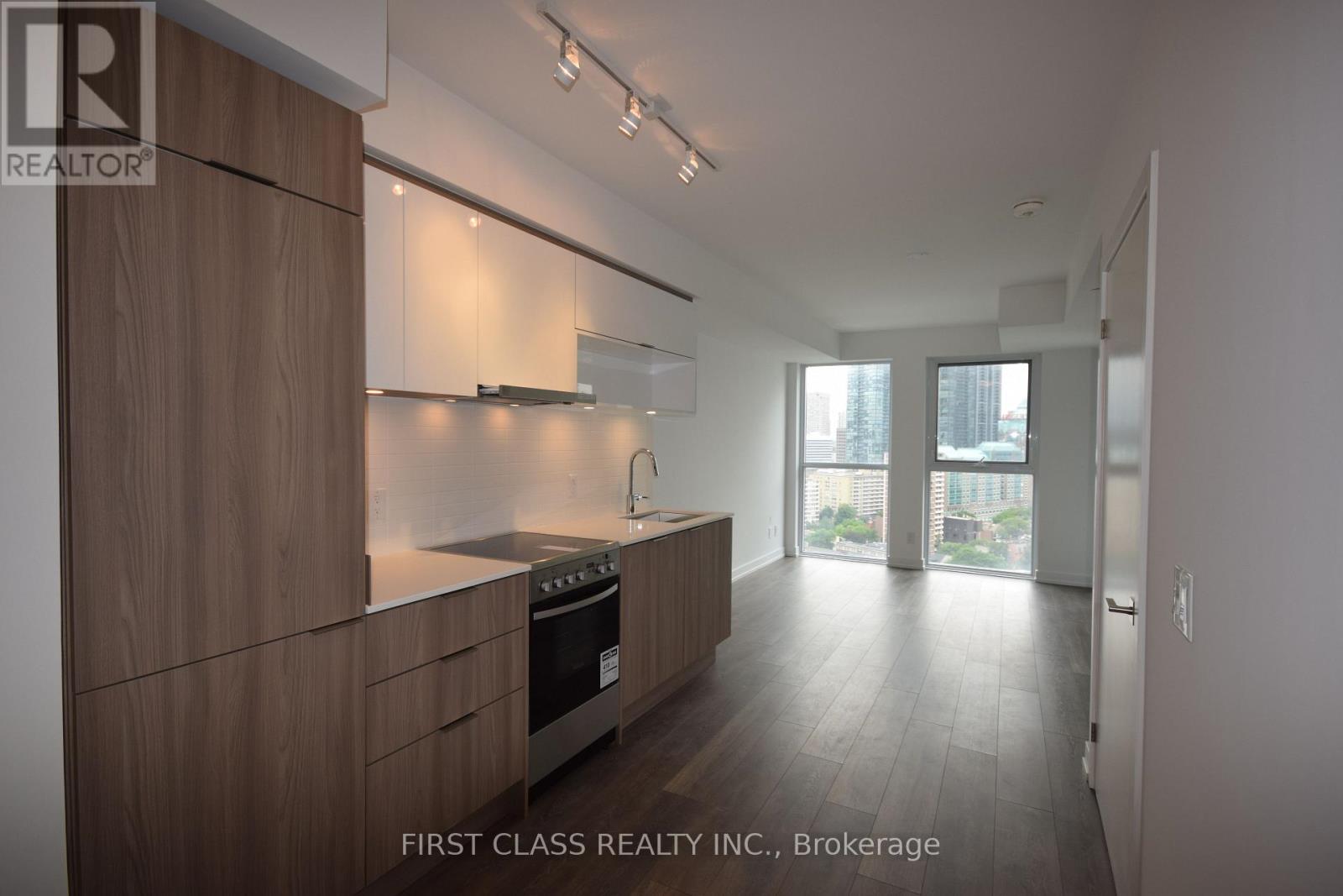 A modern kitchen with wooden cabinets and stainless steel appliances.