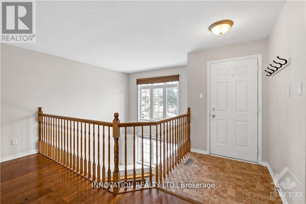 A room with a wooden railing and a white door.