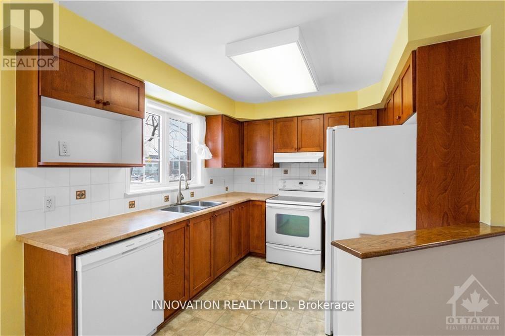 A kitchen with wooden cabinets and white appliances.