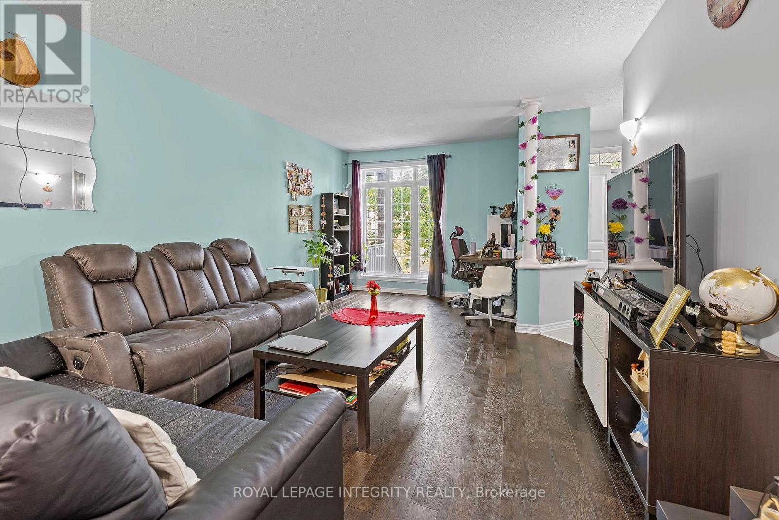 A living room with a brown leather couch and a wooden coffee table.