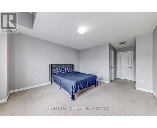 A bedroom with a bed and a door.