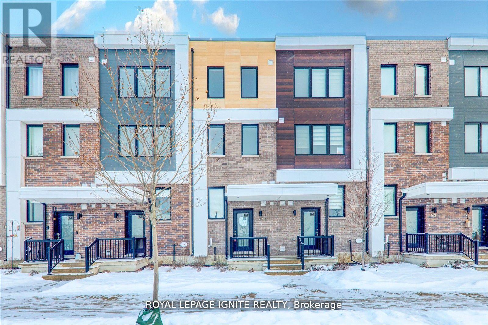 A row of townhouses with different colored exteriors.