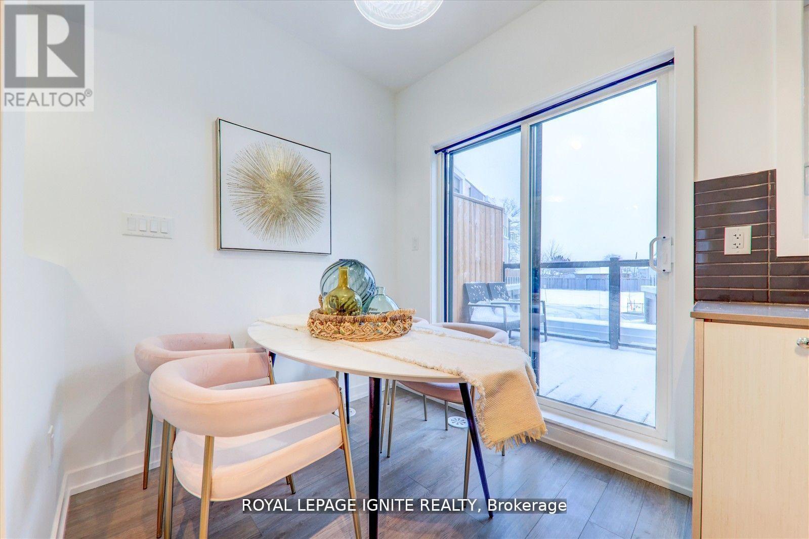 A dining room with a table and chairs.