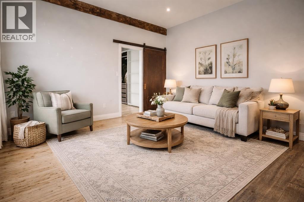 A living room with a grey sofa, a wooden coffee table, and a green plant.