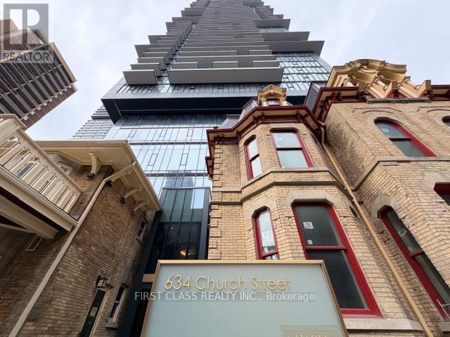 A building with the sign 634 Church Street in front of a modern skyscraper.