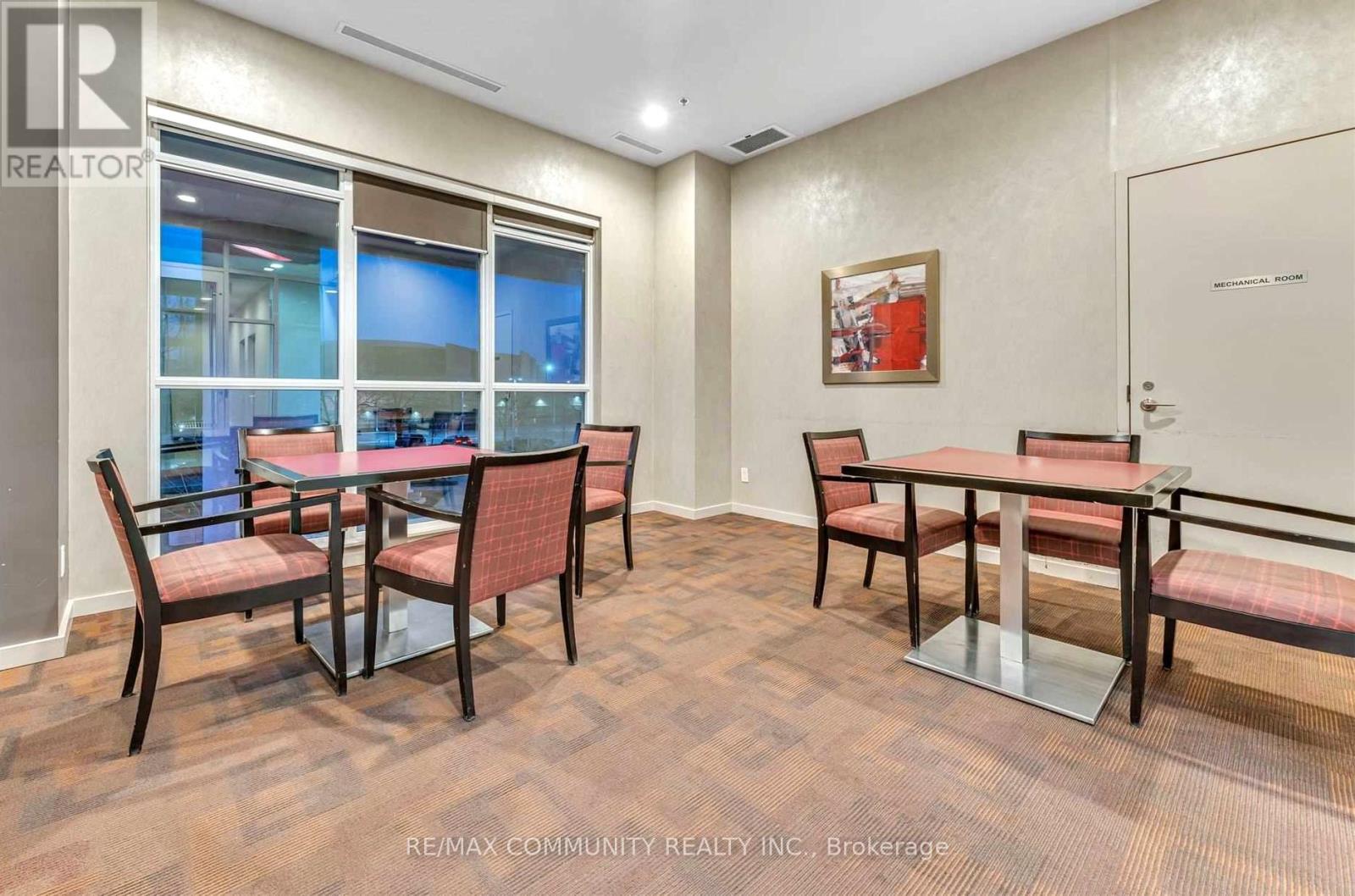 A dining room with a table and chairs.