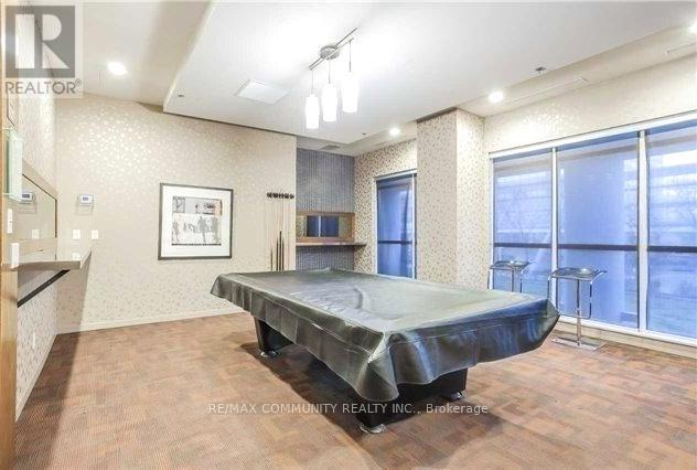 A bedroom with a large bed and a window overlooking a cityscape.