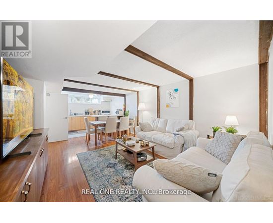 A living room with a white couch and a coffee table.