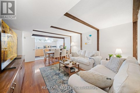 A living room with a white couch and a coffee table.