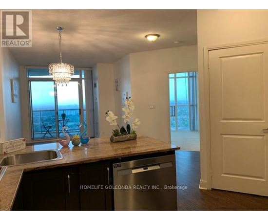 A kitchen with a sink, a window, and a chandelier.
