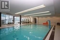 A large indoor swimming pool with a Realtor sign in the background.
