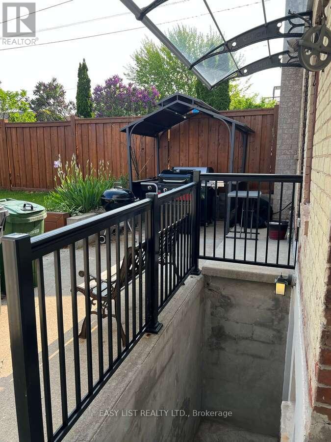 A black metal railing with a glass roof above it.