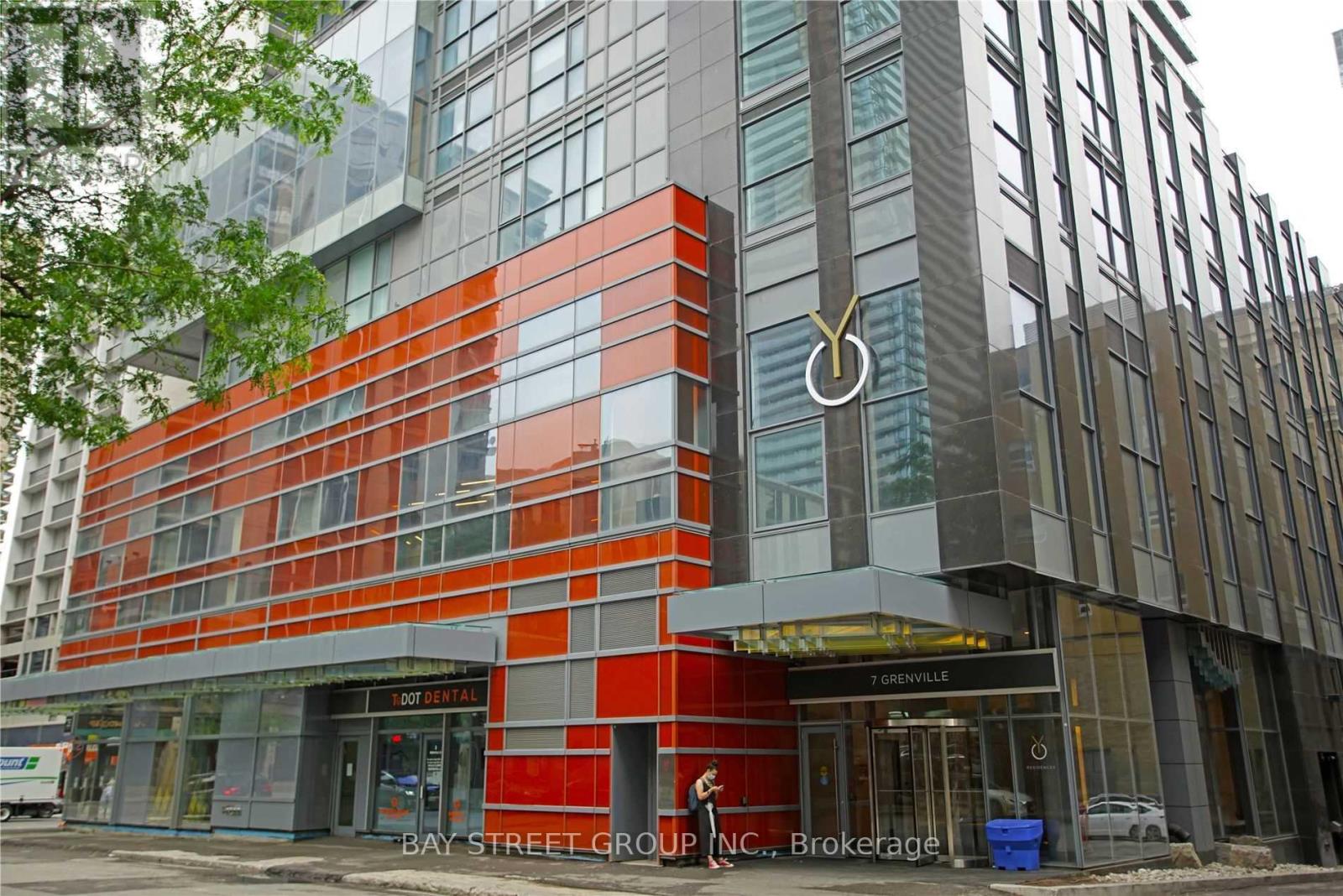 A modern building with a red and grey facade.