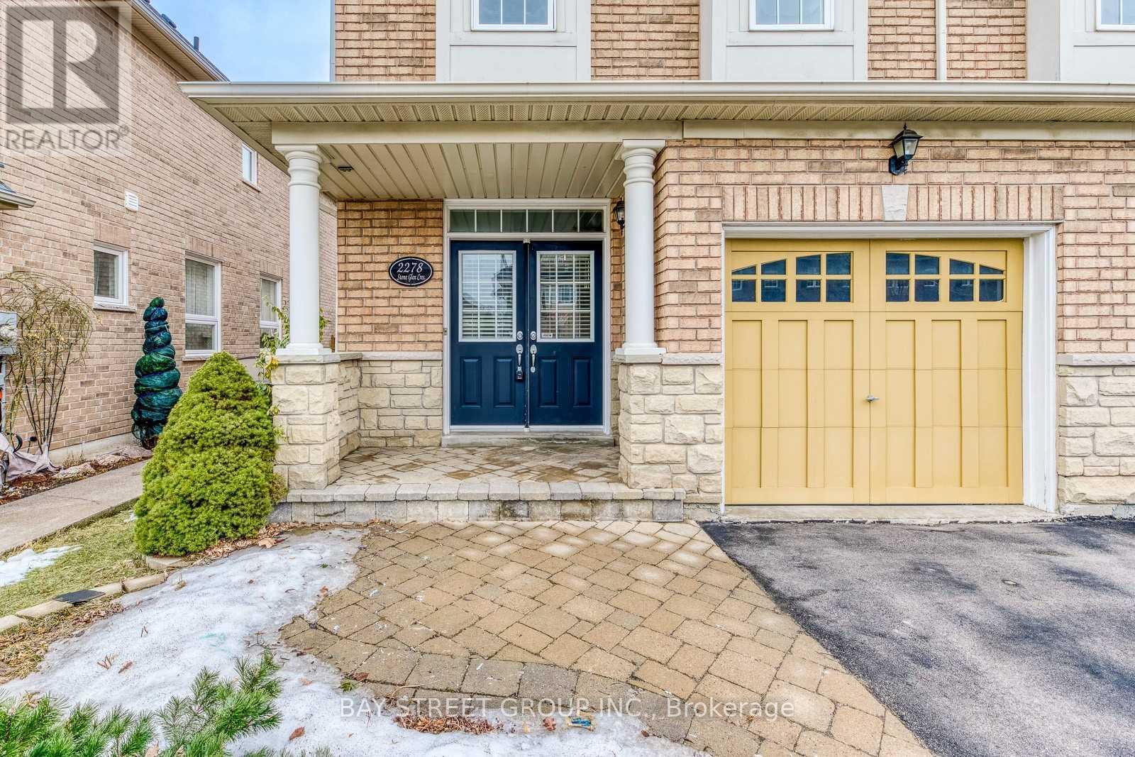 A house with a blue front door and a yellow garage door.
