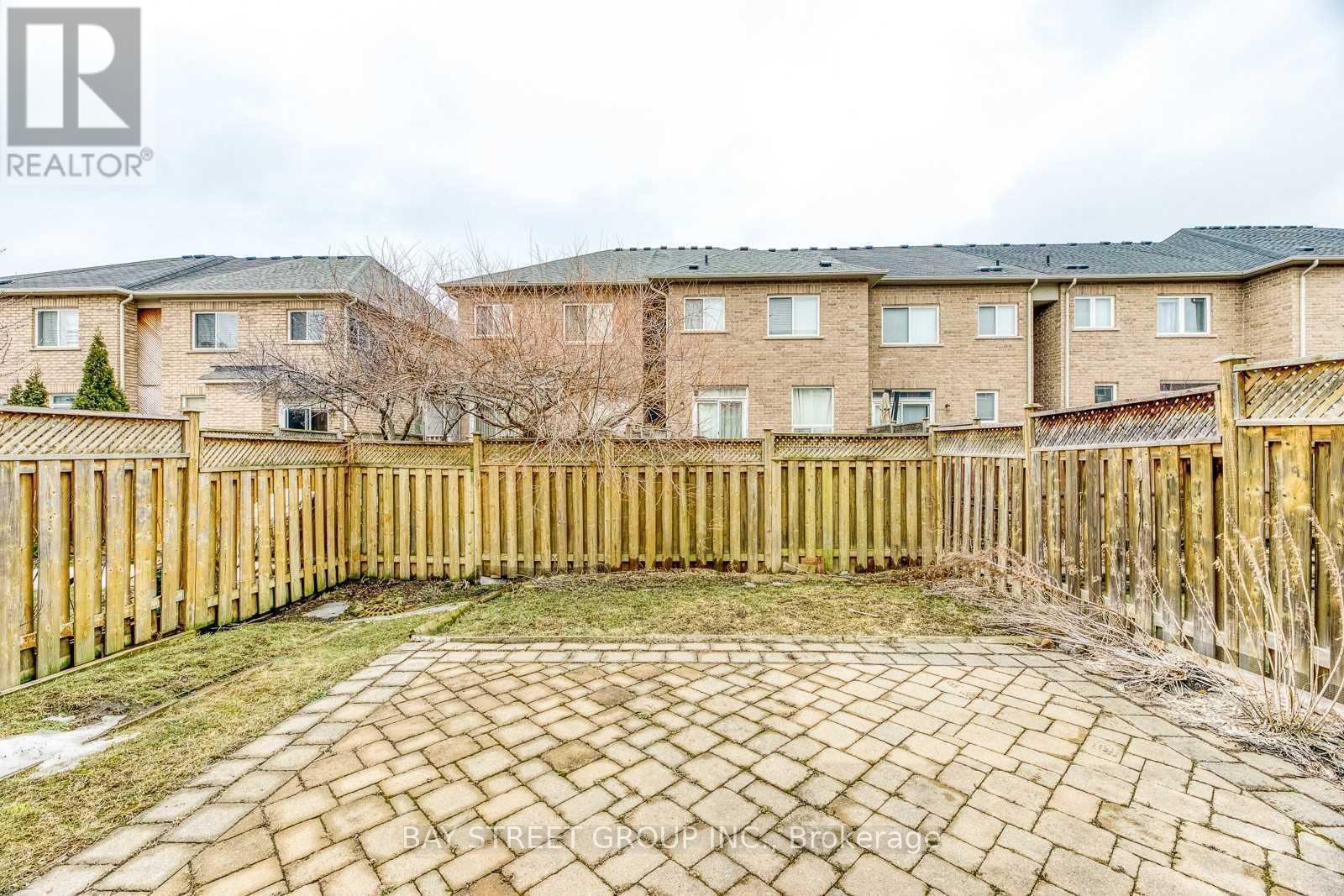 A brick building with a wooden fence in front.