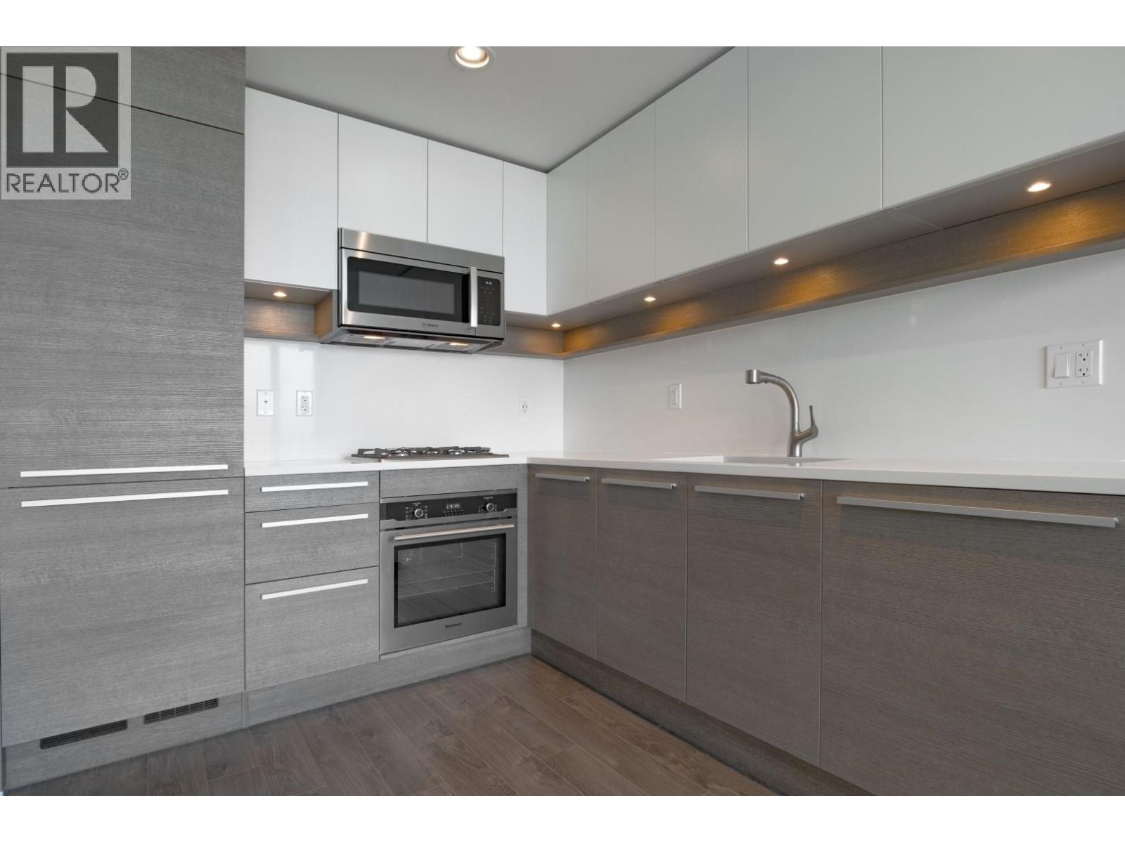 A modern kitchen with a microwave above the stove.