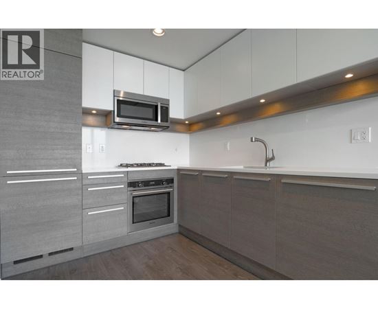 A modern kitchen with a microwave above the stove.