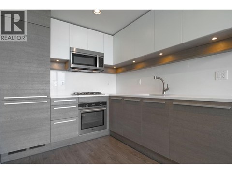 A modern kitchen with a microwave above the stove.