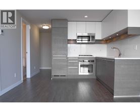 A modern kitchen with a stainless steel oven and a microwave above it.