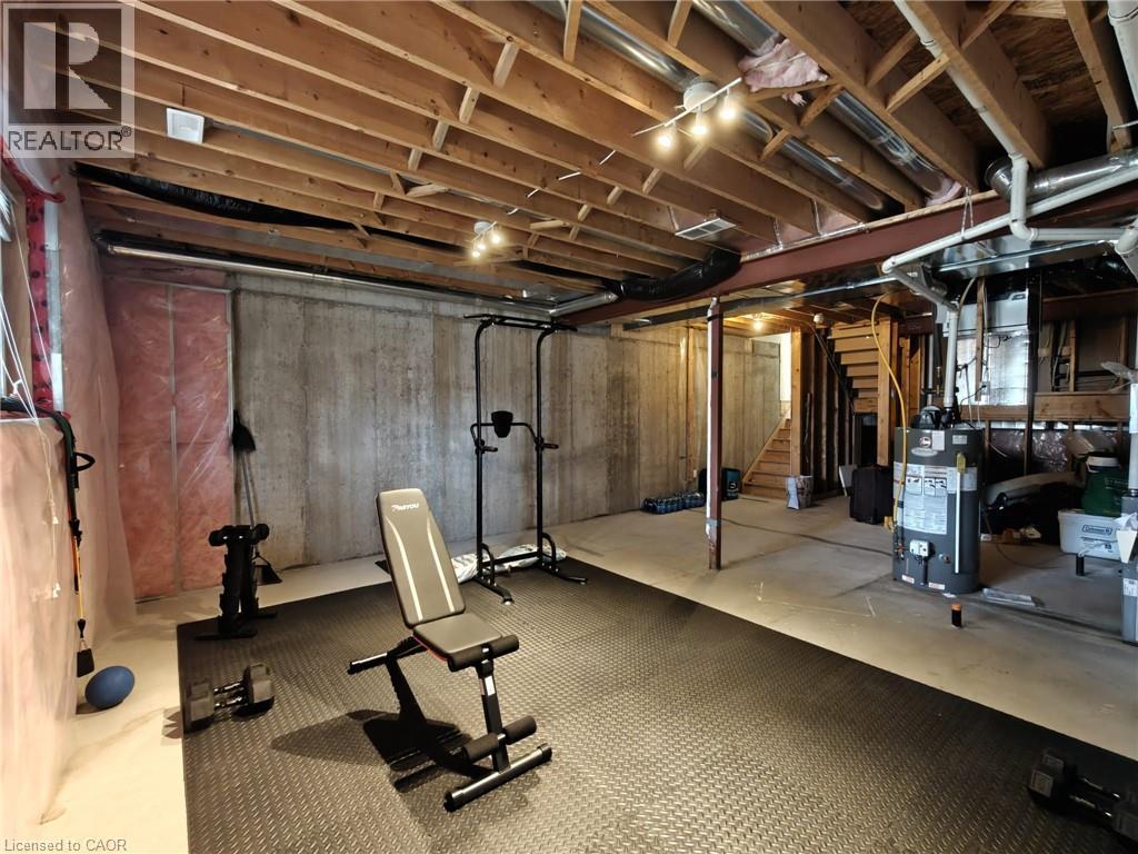 A gym with a wooden ceiling and a variety of exercise equipment.