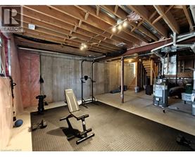 A gym with a wooden ceiling and a variety of exercise equipment.